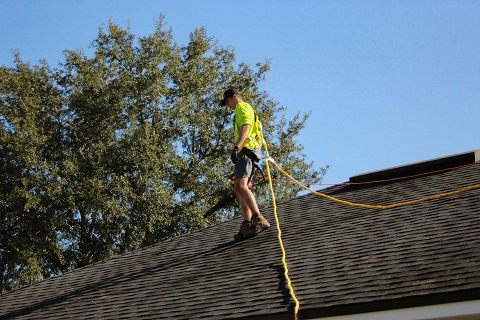 person working on the roof of a house in scottsdale, az